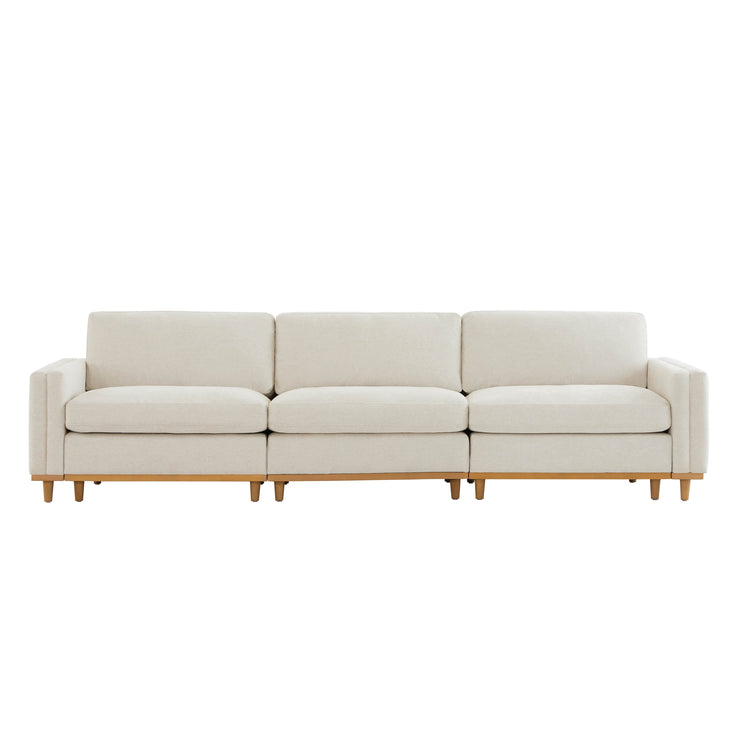 Liam 3-Piece Overstuffed Sofa with beige cushions and wooden base in bright room - CHITA Living
