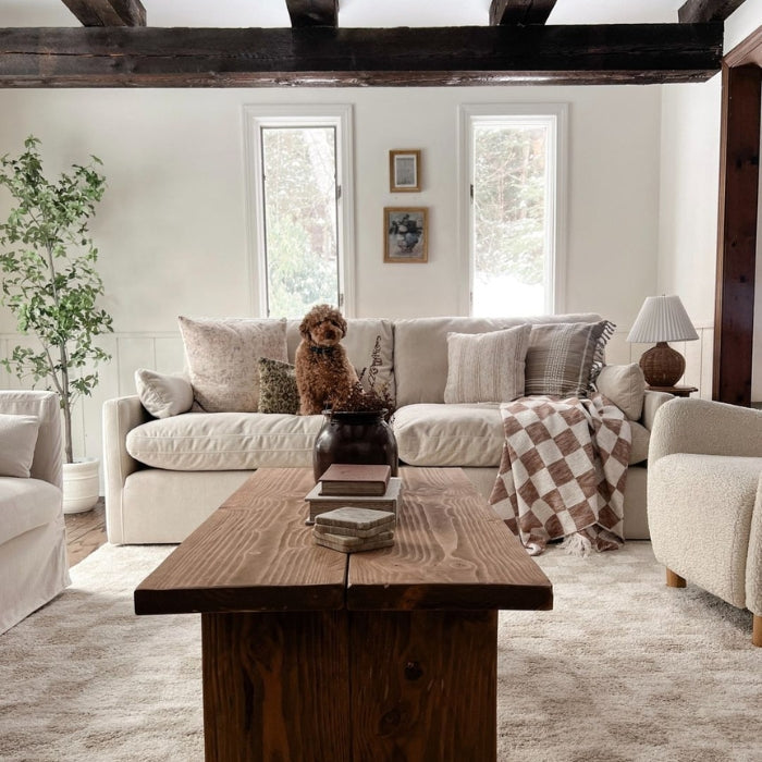 A cozy living room with a white sofa, a wooden coffee table
