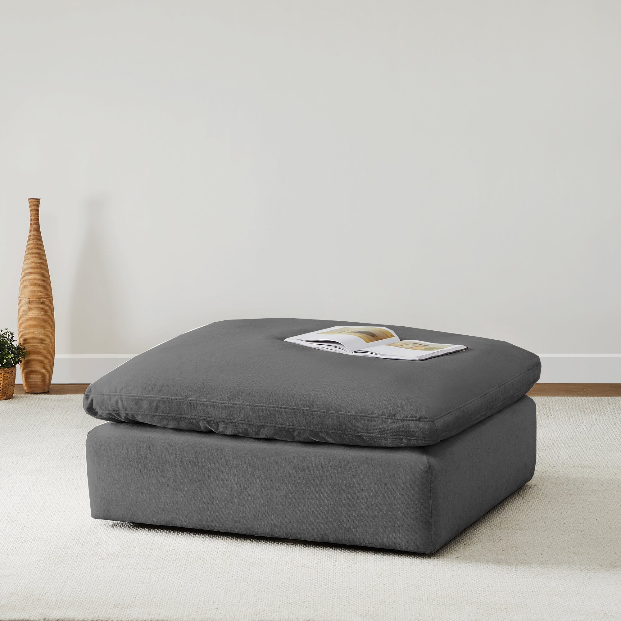 Gray Kenna Ottoman, modern living room furniture with a book on top, part of modular sofa collection