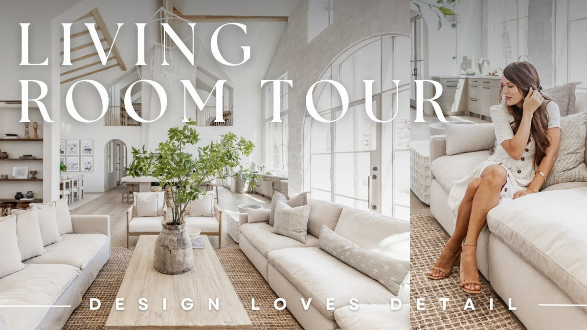 A modern living room with white sofas, a large plant, and text overlay 
