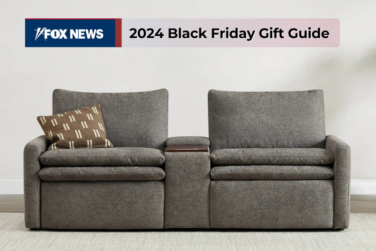 A gray reclining loveseat with a patterned pillow