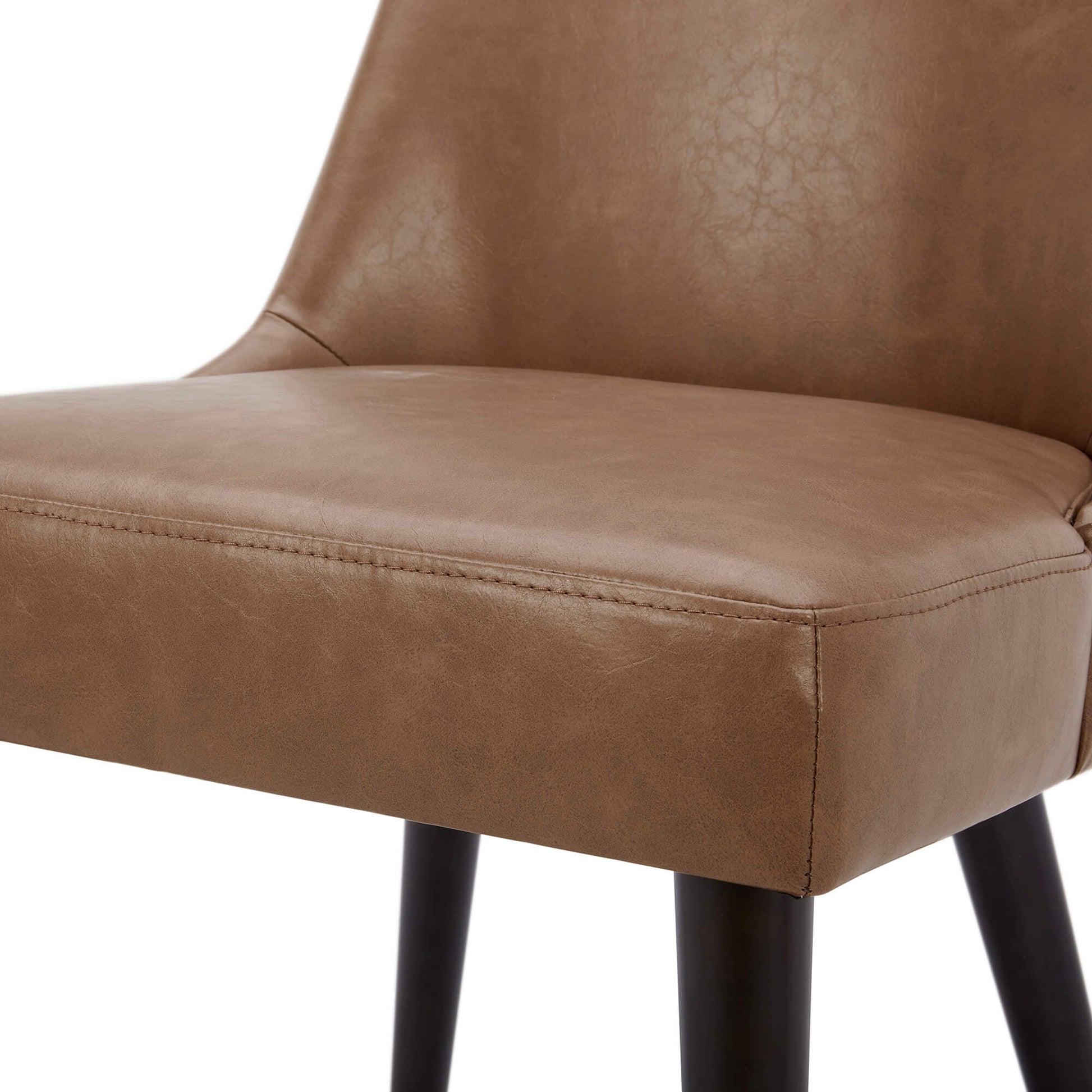 Close-up of Rhett Dining Chair's brown faux leather seat highlighting modern design - CHITA Living