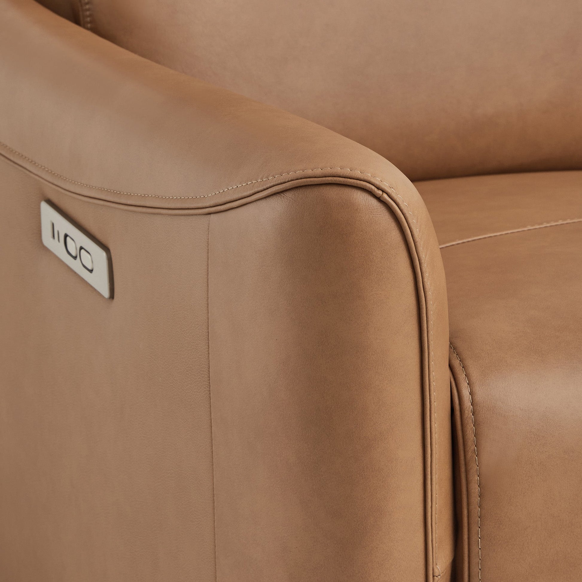 Close-up of Tracee brown power swivel recliner's sleek arm and USB port - CHITA Living