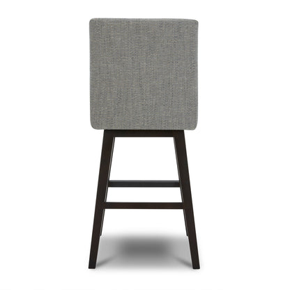 Back view of Lissa Swivel Bar Stool with soft grey fabric seat and dark wood legs - CHITA Living