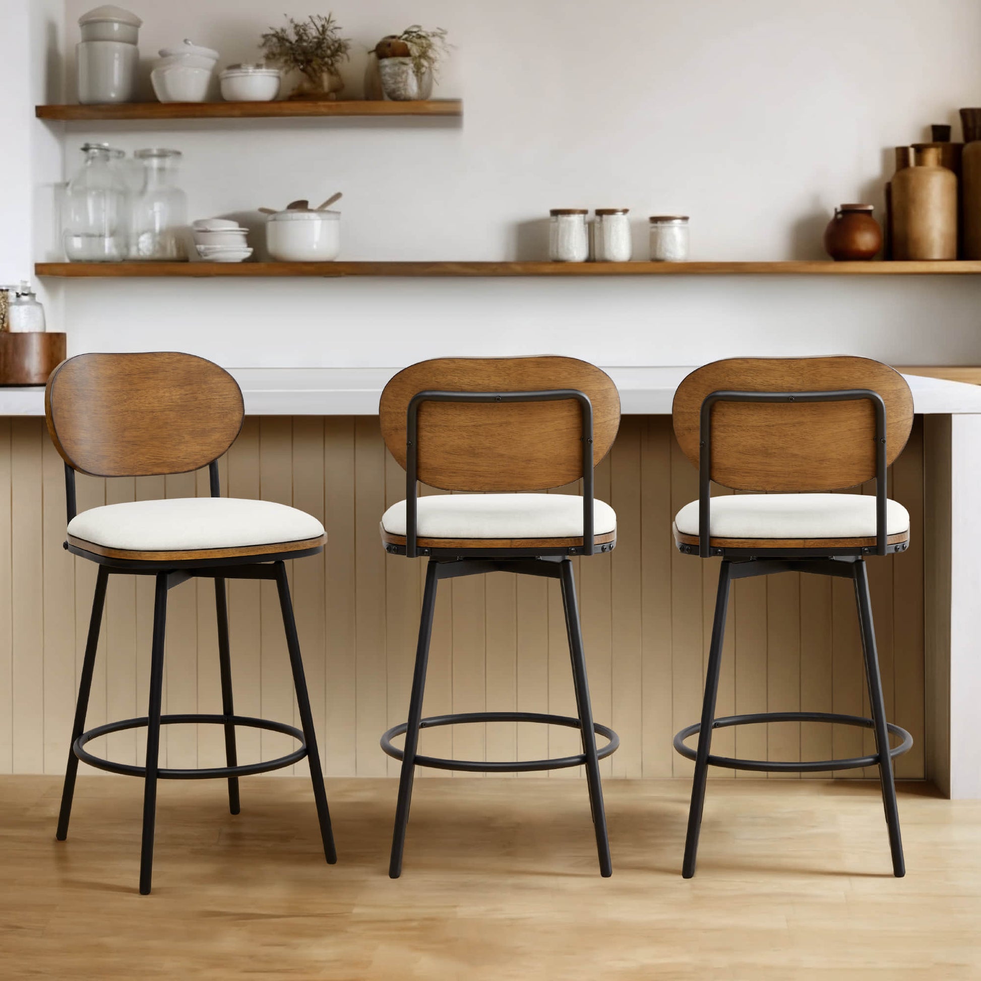 Set of three Aislinn swivel bar stools with cream seats and wooden backs at a kitchen island - CHITA Living