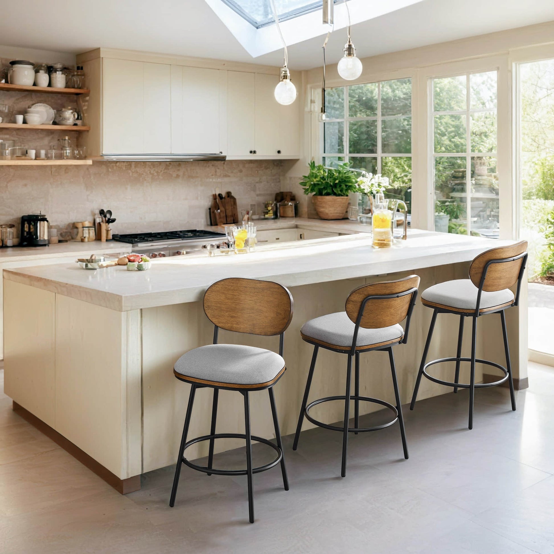Set of three Aislinn swivel bar stools with wood backs and gray cushions at a kitchen island - CHITA Living