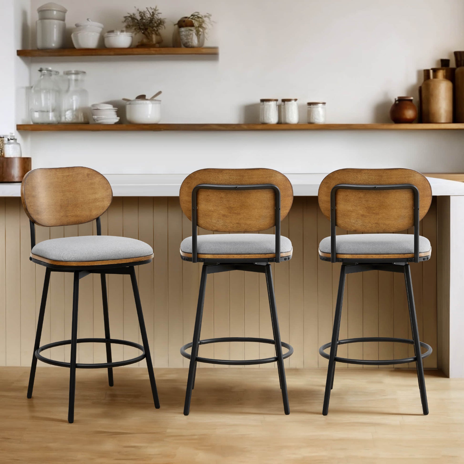 Three Aislinn swivel bar stools with gray cushions and wood backs in contemporary kitchen - CHITA Living