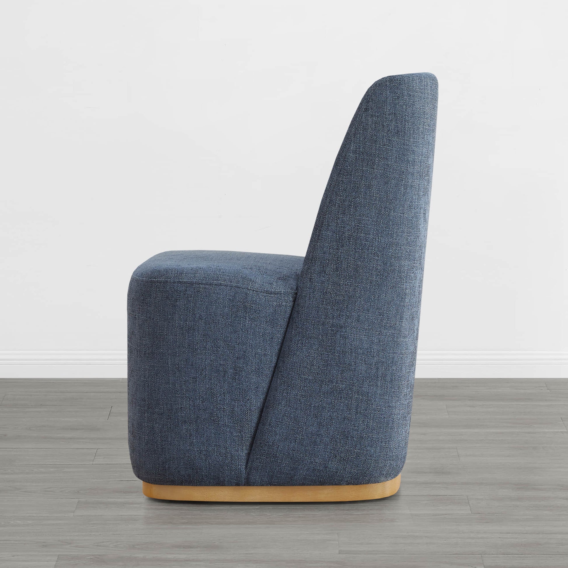 Side view of blue upholstered wingback dining chair with wooden base - CHITA Living