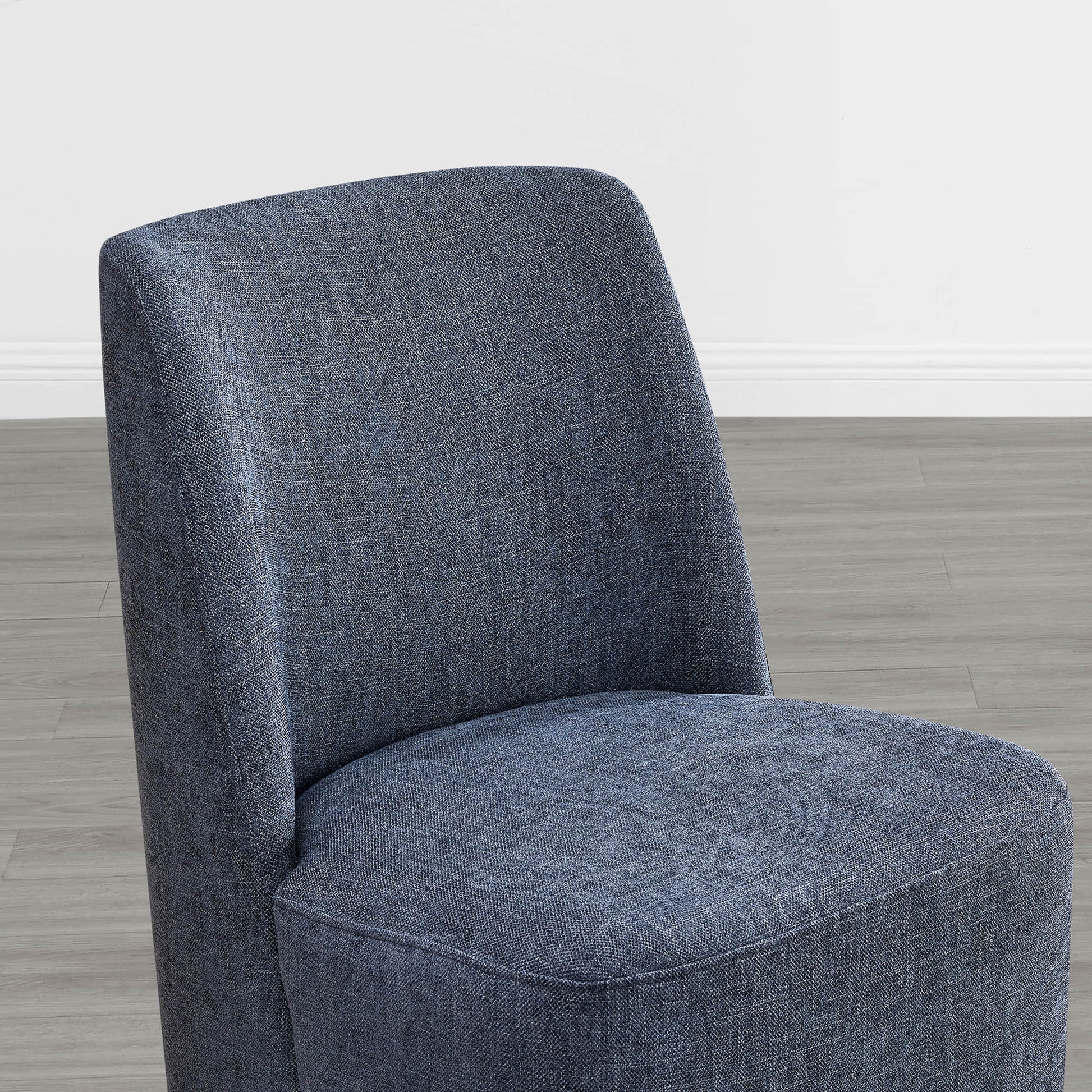 Close-up of textured blue fabric dining chair showcasing curved design - CHITA Living