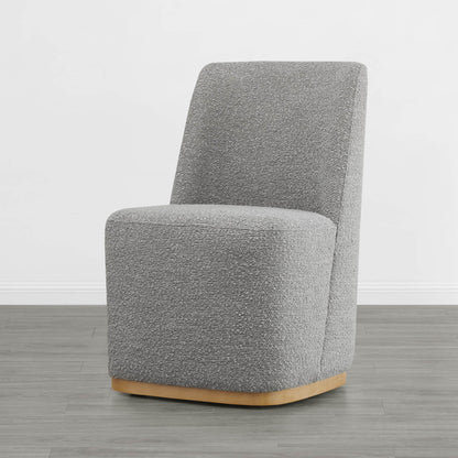 Curved gray dining chair with textured upholstery and wooden base in modern interior - CHITA Living