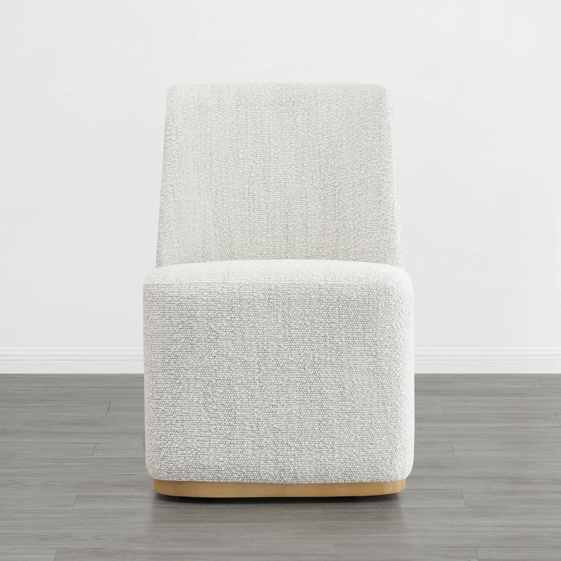 Textured cream wingback dining chair with a curved wooden base in a minimalist setting - CHITA Living