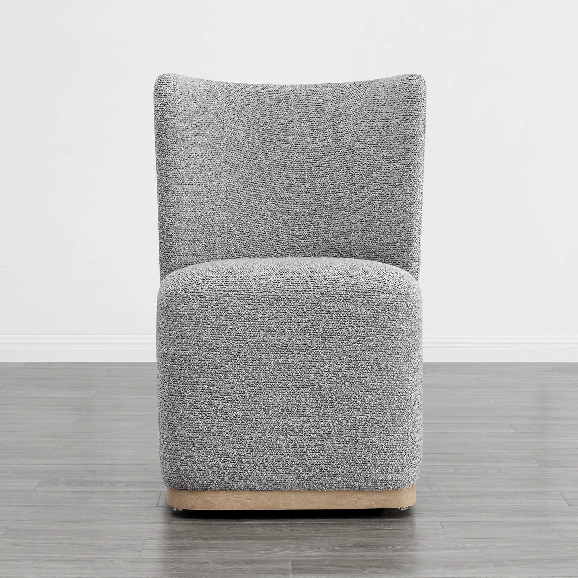 Gray boucle upholstered dining chair with a curved design in a modern setting - CHITA Living