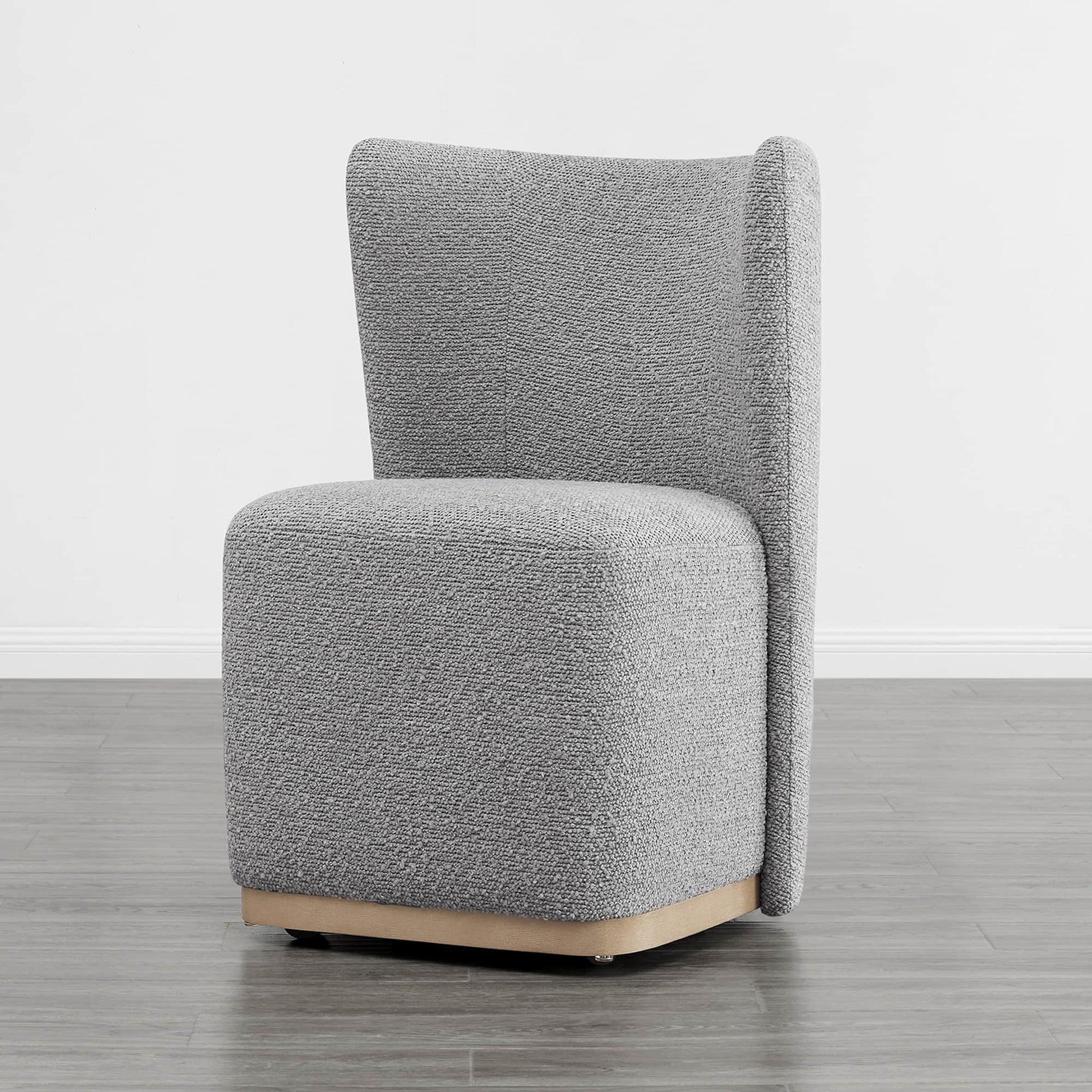 Gray textured upholstered wingback chair with a curved base in a minimalist setting - CHITA Living