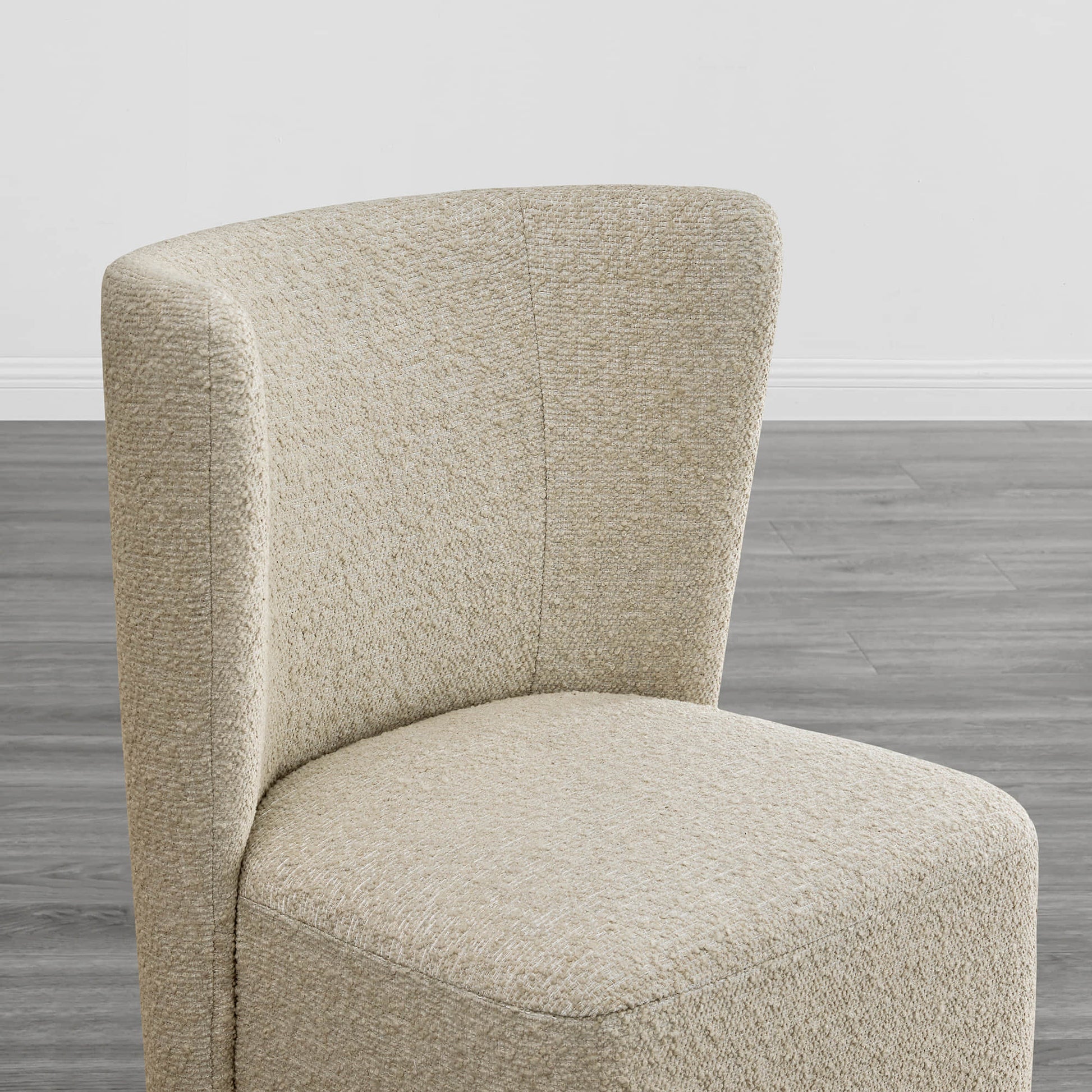 Close-up of a beige textured wingback dining chair showcasing curved design - CHITA Living