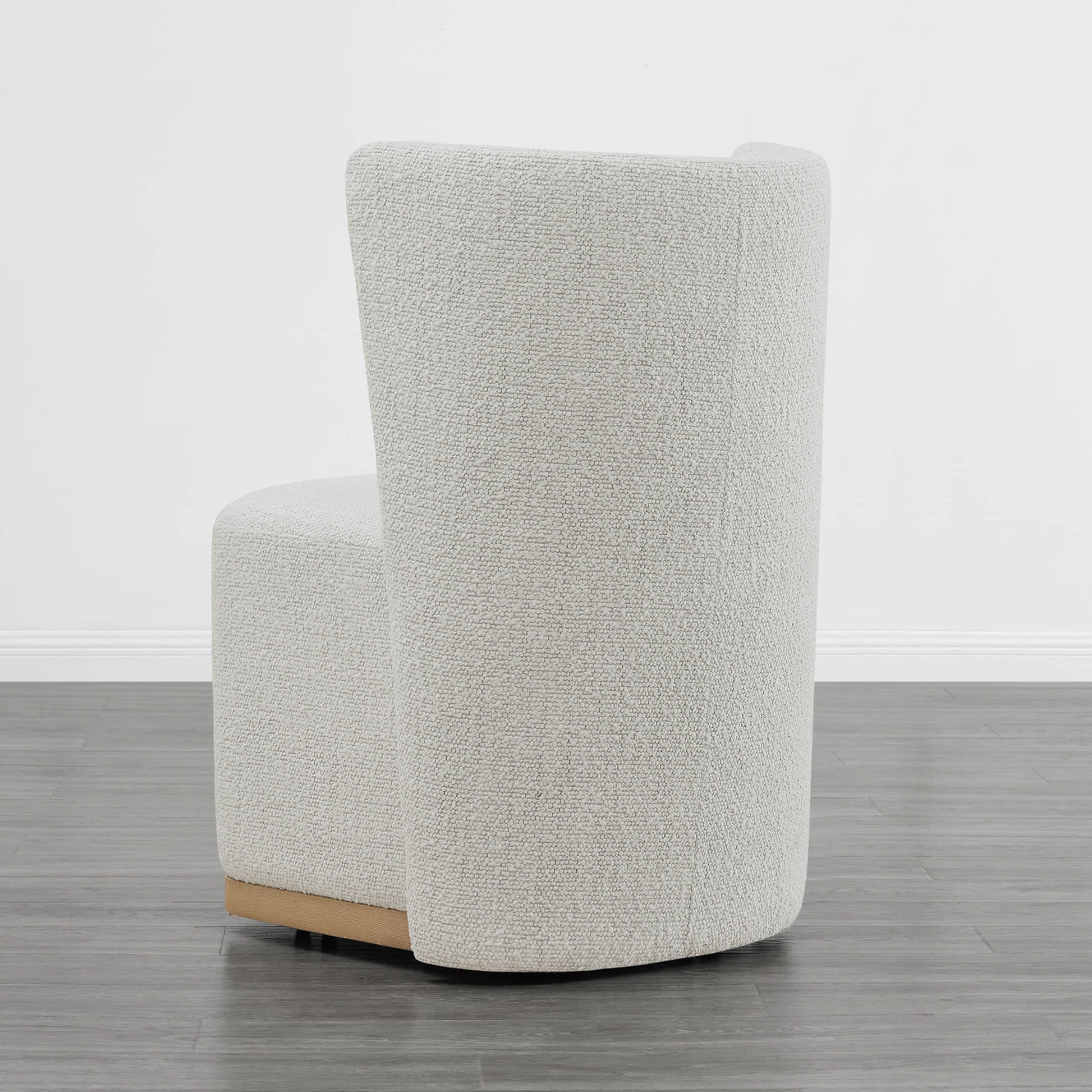 Back view of cream textured wingback chair with curved design in minimalist setting - CHITA Living