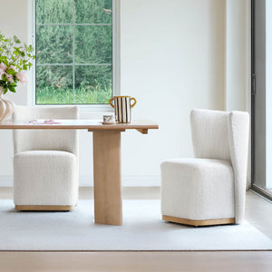 Stylish wingback chairs in textured fabric beside a wooden dining table in a bright room - CHITA Living