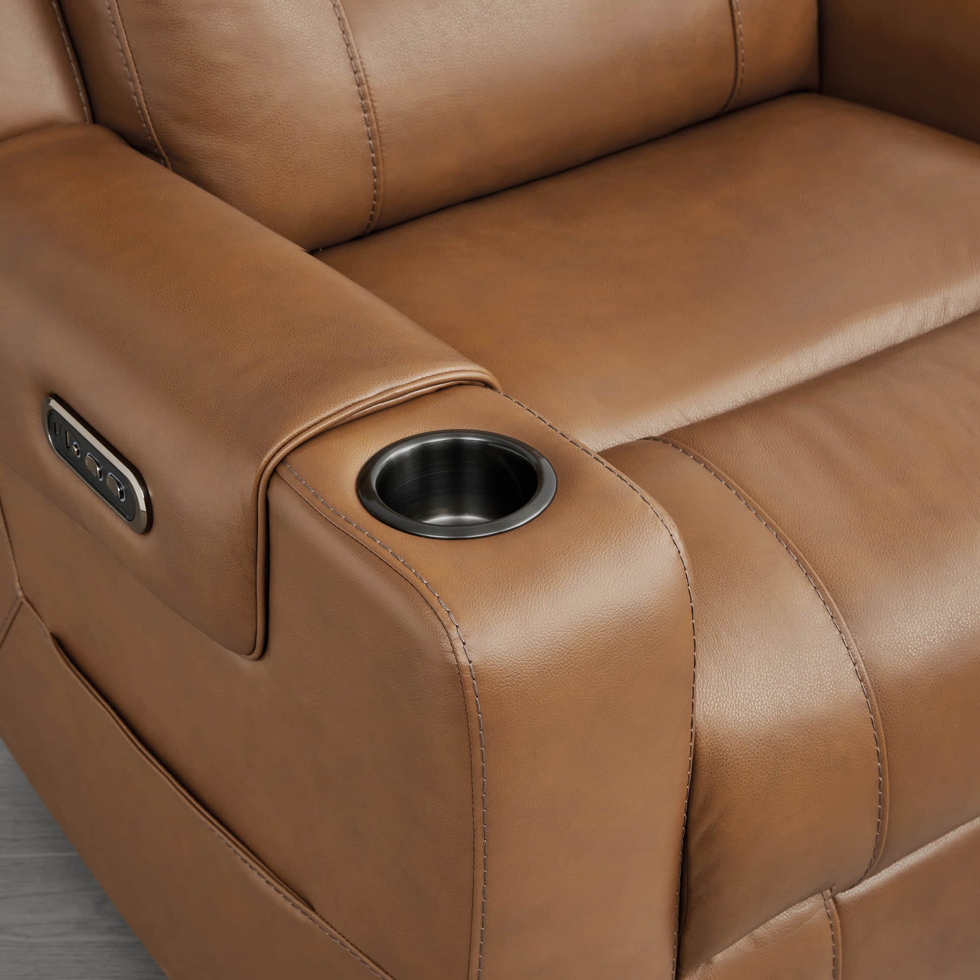 A tan leather recliner with a built-in cup holder and control panel on the armrest.