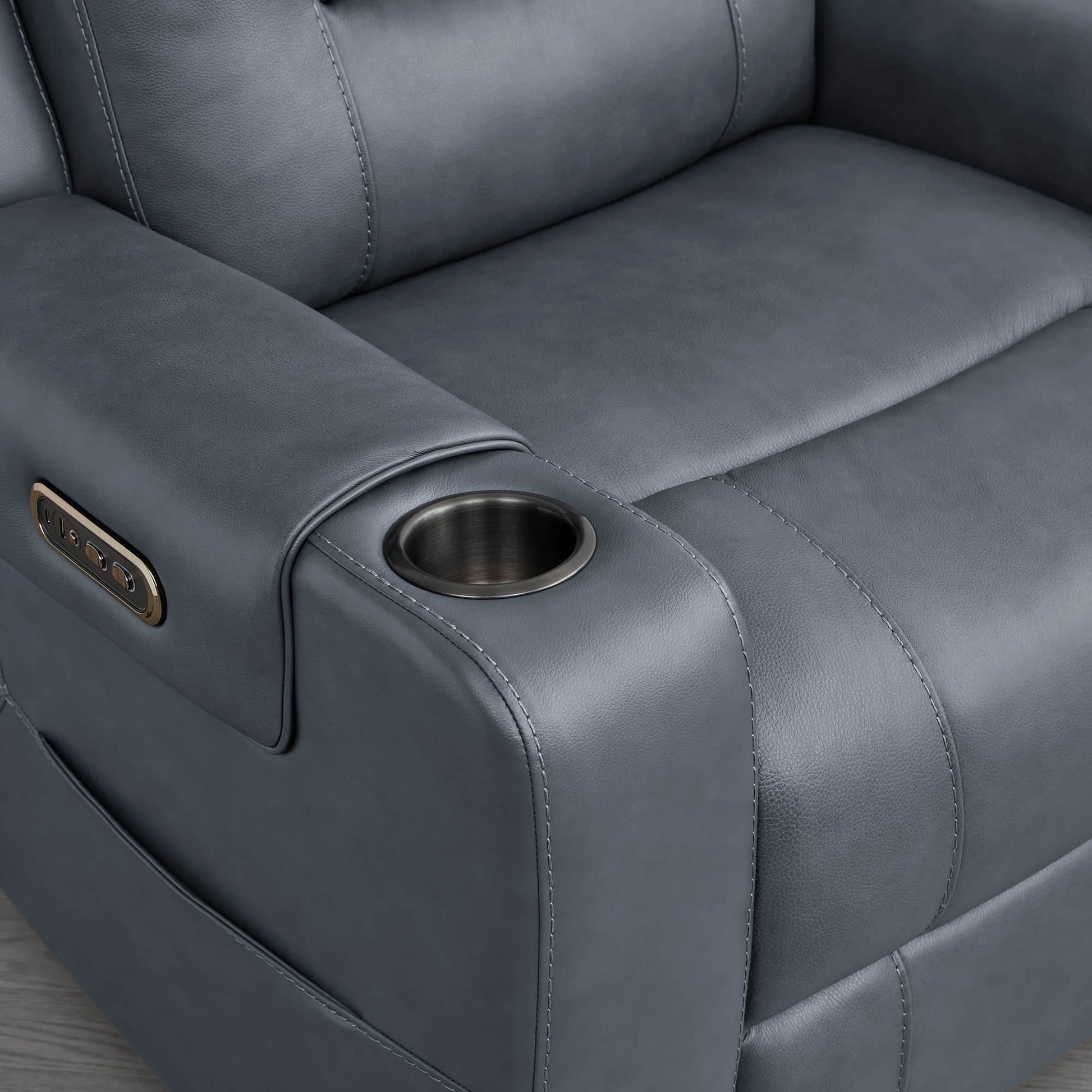 A dark blue leather recliner armrest with a built-in cup holder and control panel.