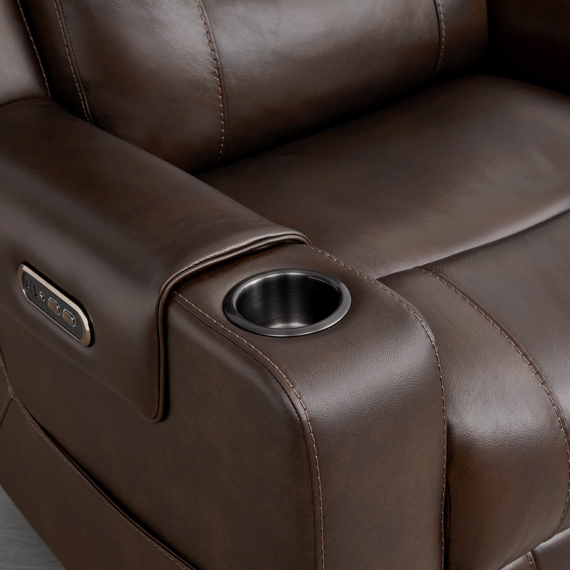 
A dark brown leather recliner armrest with a built-in cup holder and control panel.