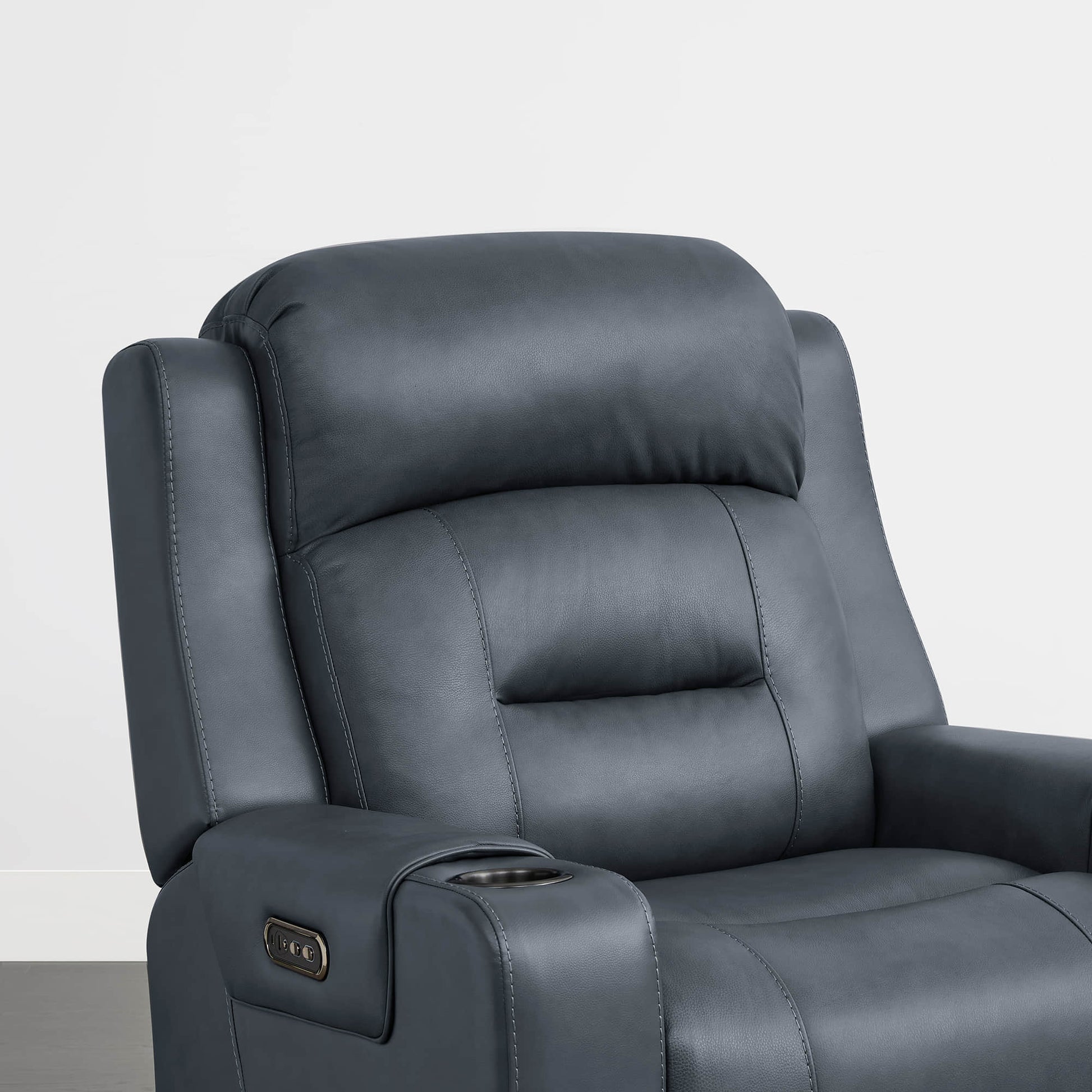 A dark blue leather recliner with a plush headrest and built-in cup holder in the armrest.