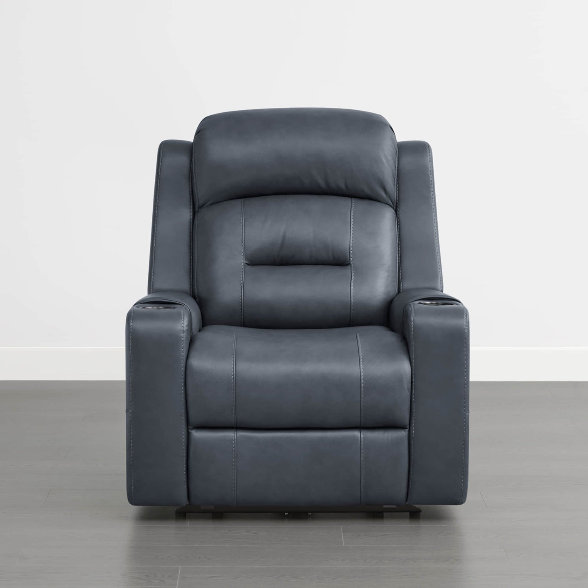A dark blue leather recliner with cup holders in the armrests, set against a plain background.