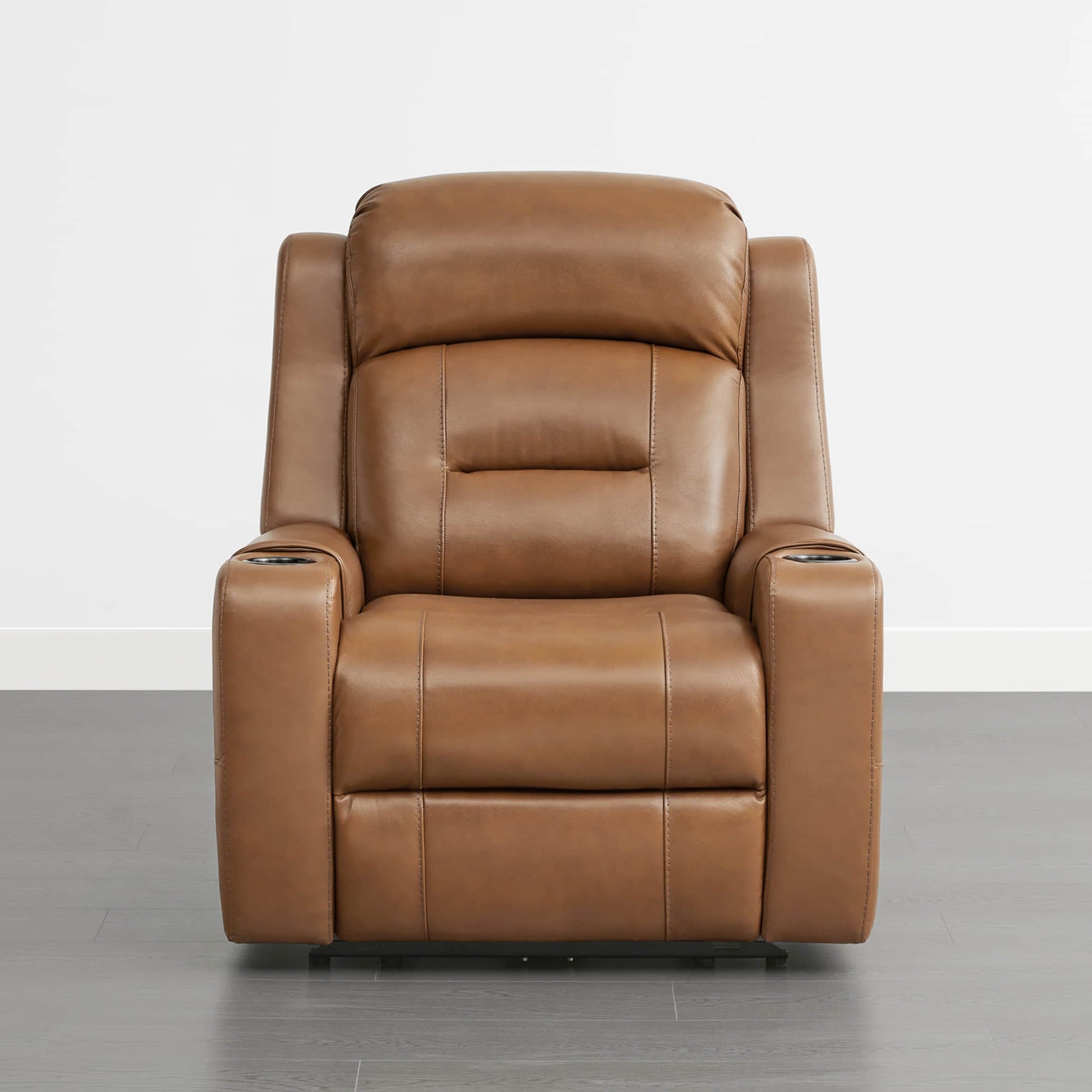 A tan leather recliner with cup holders in the armrests, set against a plain background.