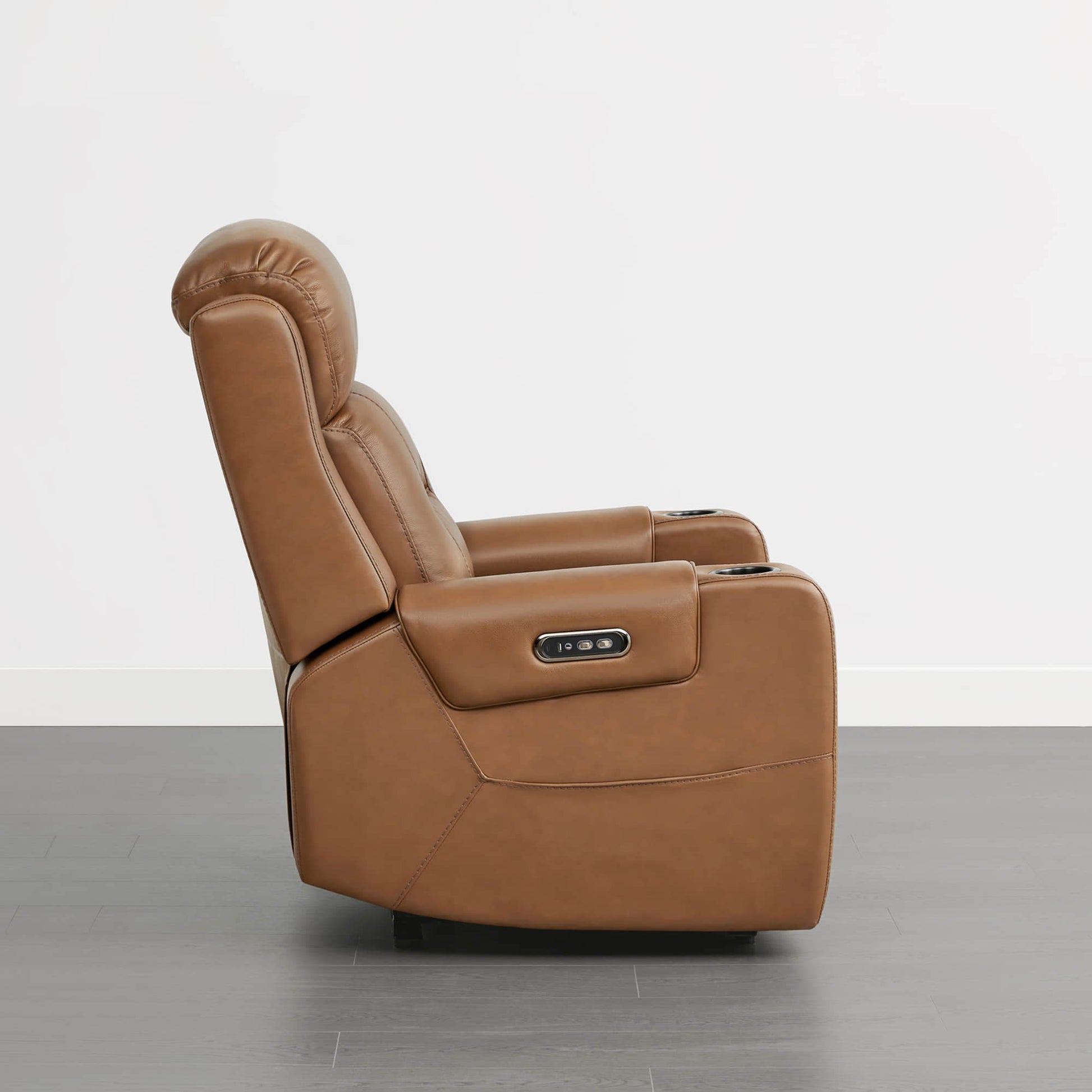A tan leather recliner with a power headrest, cup holders, and control panel on the armrest.