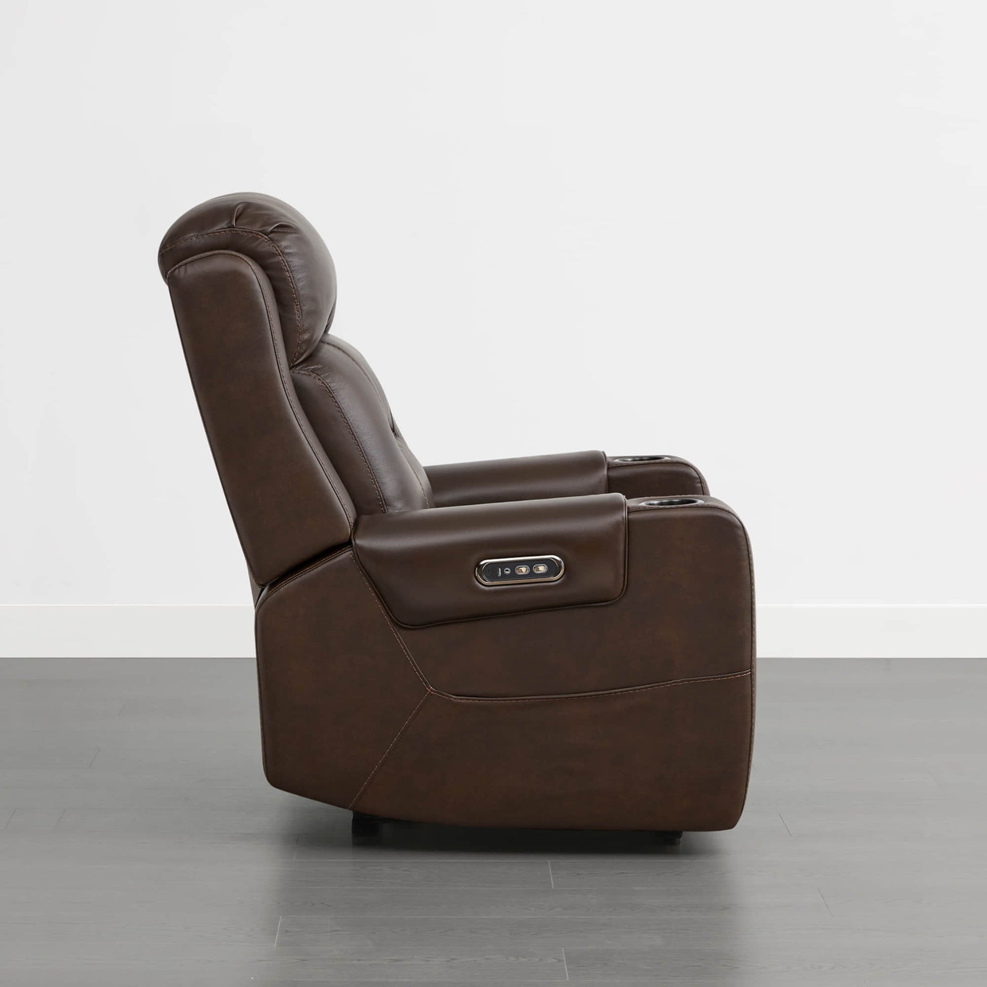 A dark brown leather recliner with a power headrest, cup holders, and control panel on the armrest.