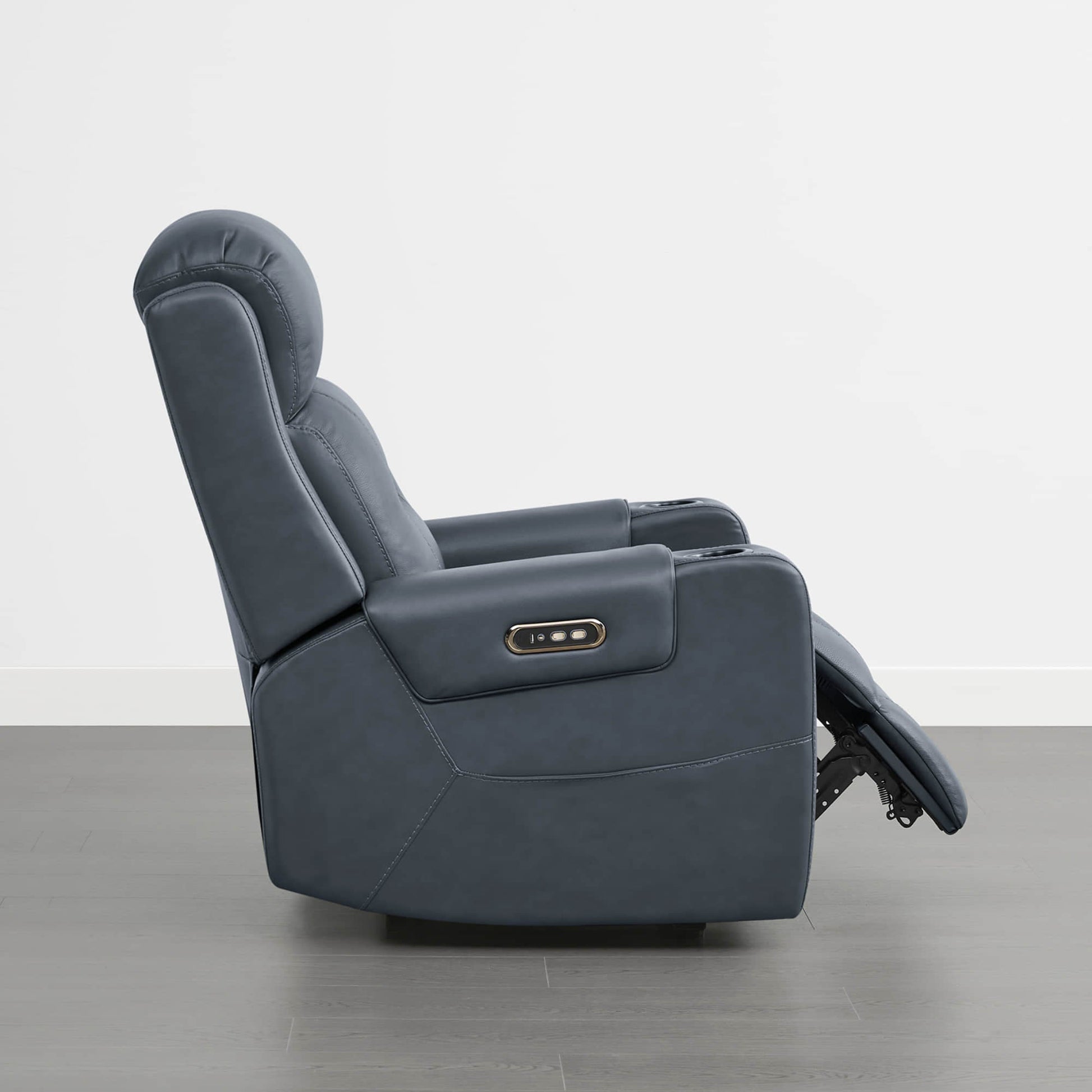 A dark blue leather recliner with a control panel on the armrest and a plush headrest.