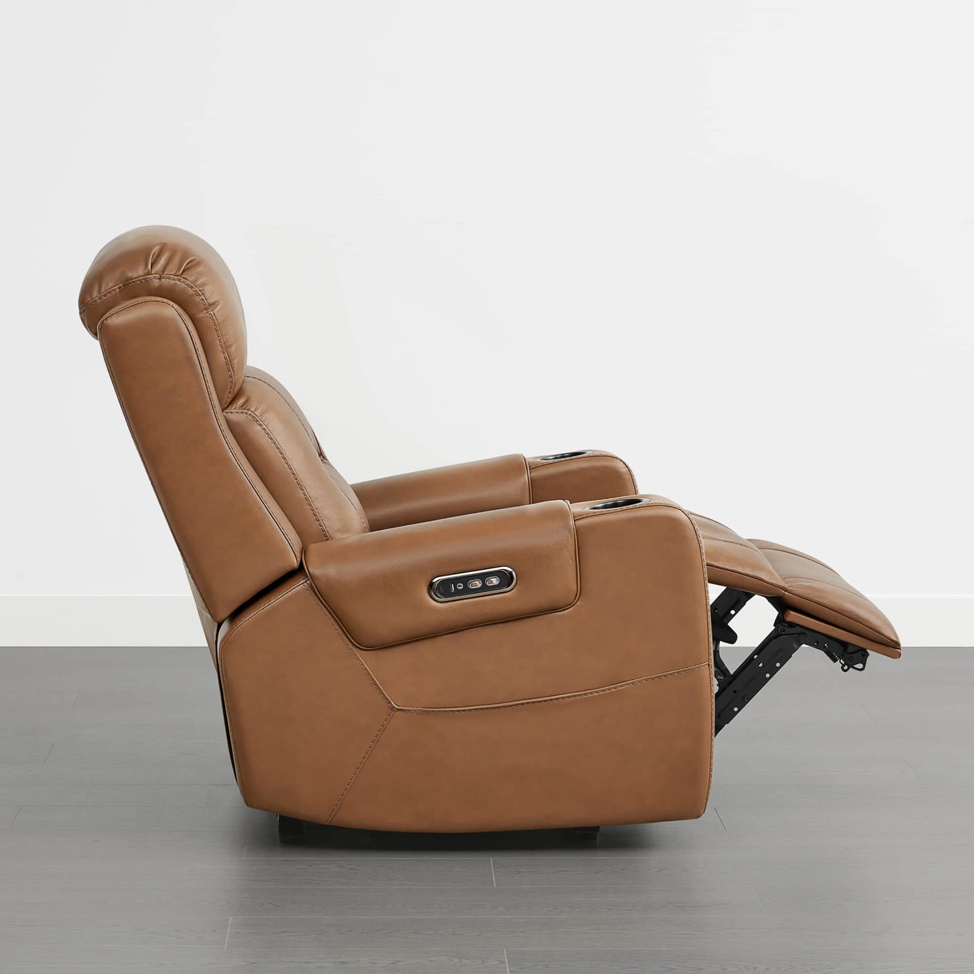 A tan leather recliner with a power headrest, cup holders, and control panel on the armrest.