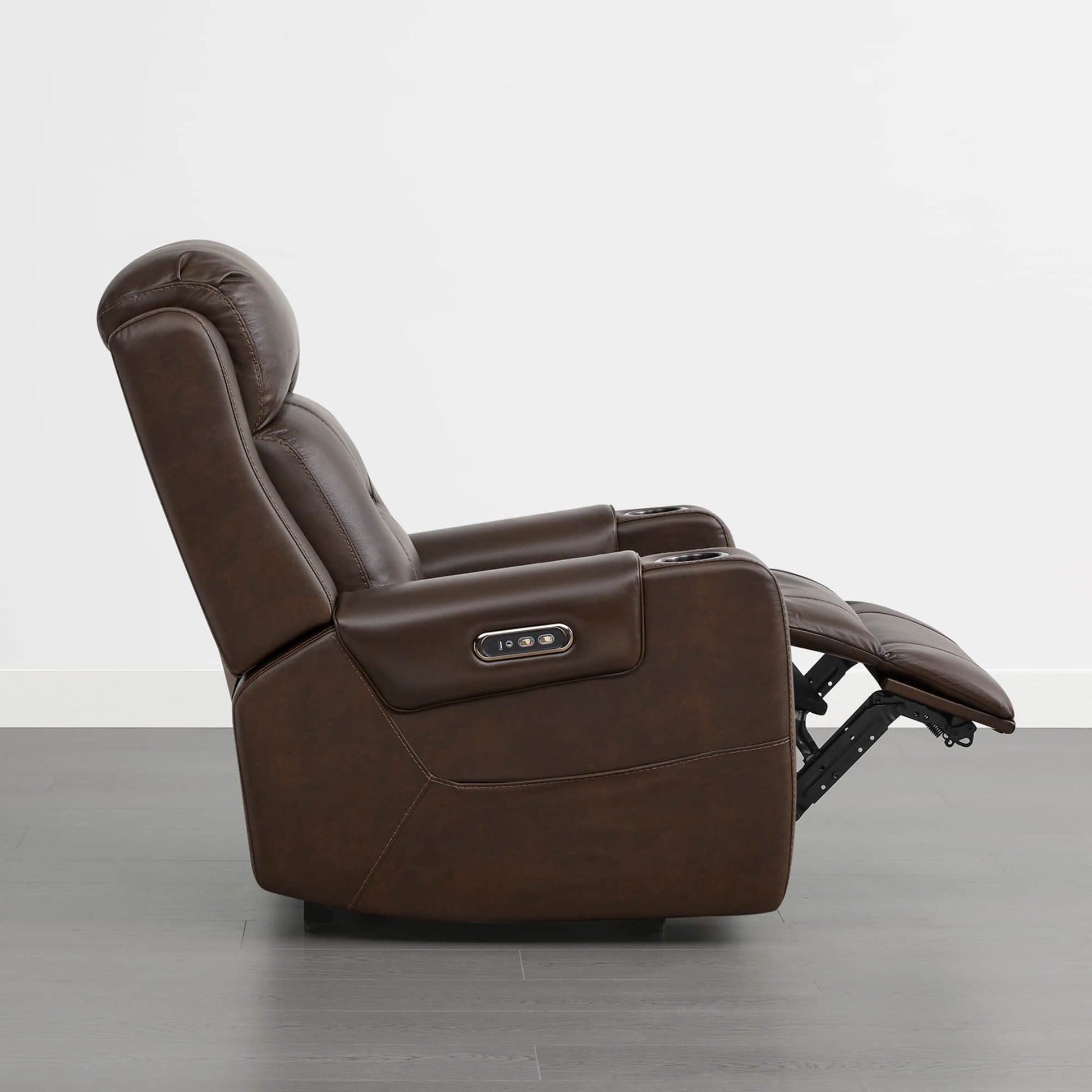A dark brown leather recliner with a power headrest, cup holders, and control panel on the armrest.