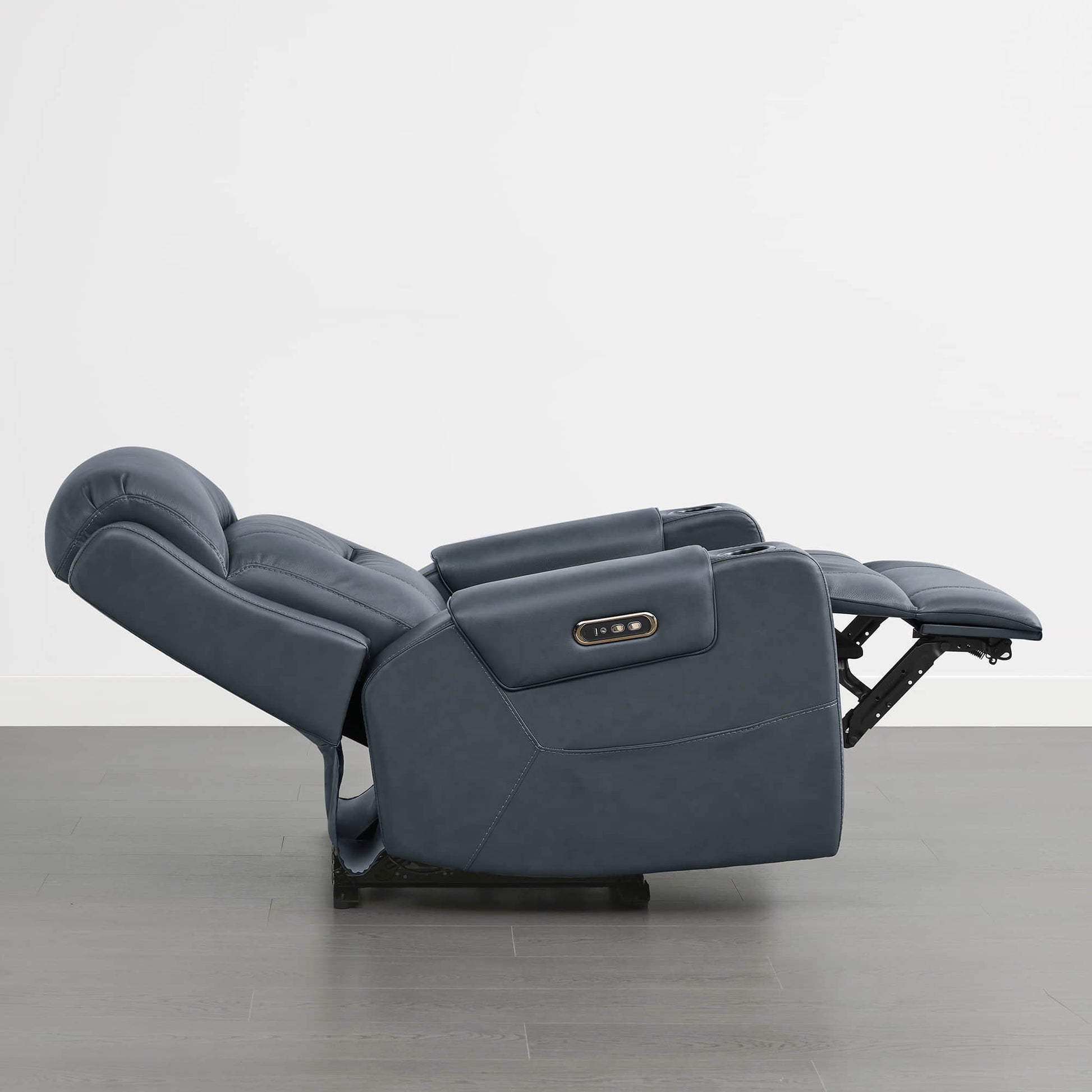A dark blue leather recliner in the fully reclined position with a control panel on the armrest.