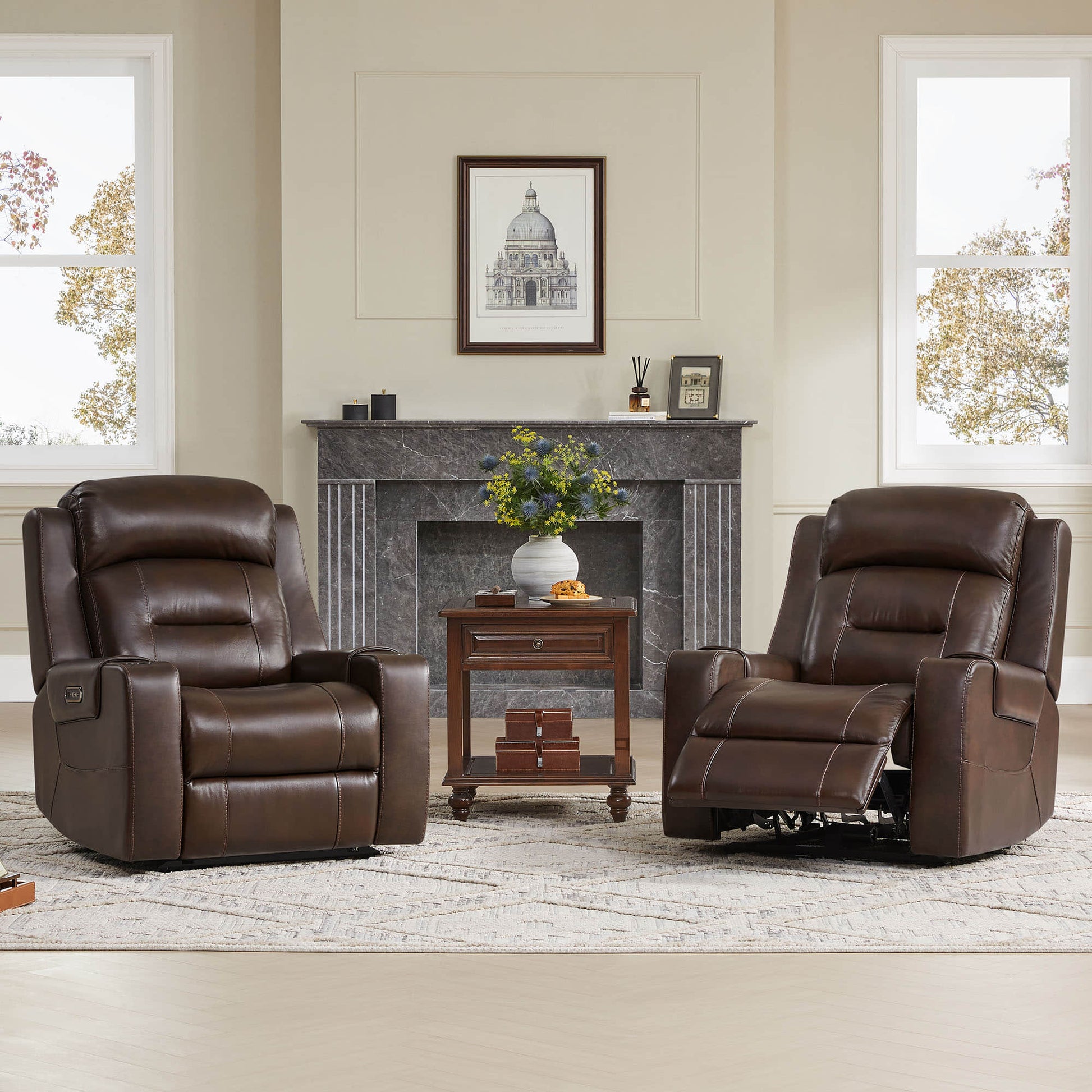 Two brown leather recliners with power headrests in a living room with a fireplace and side table.