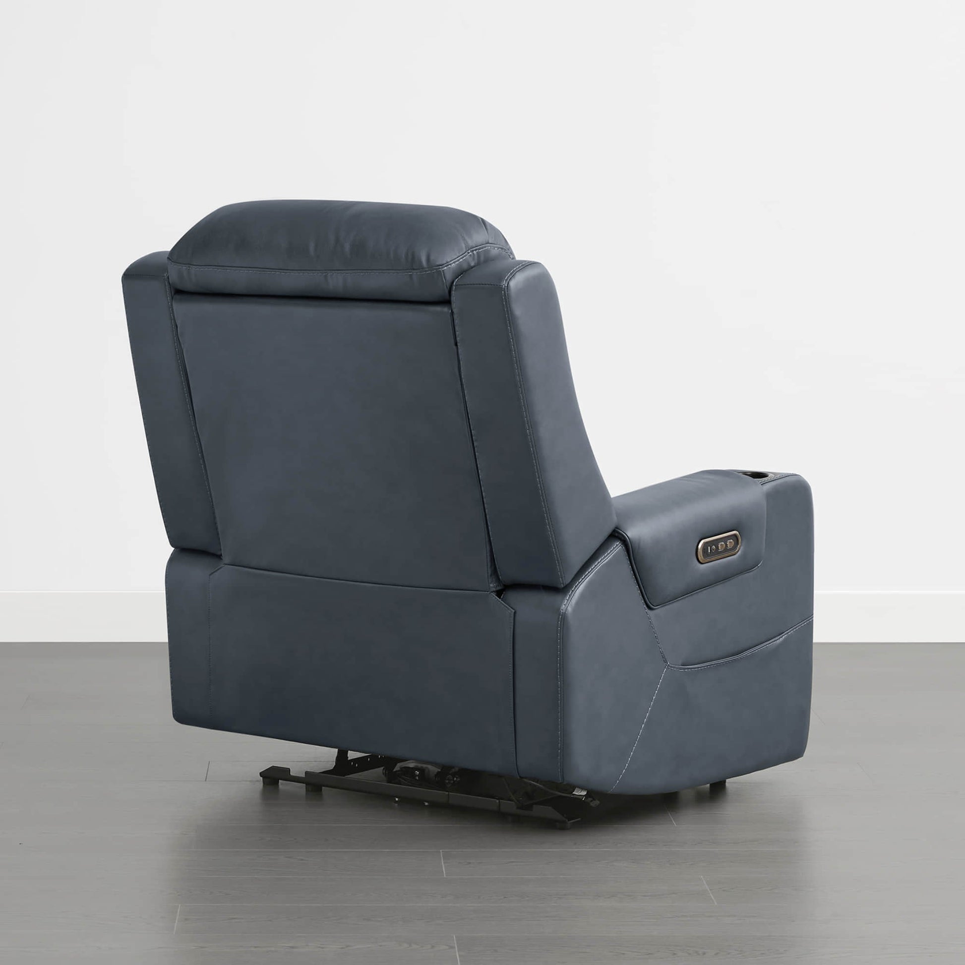 A dark blue leather recliner with a control panel on the armrest, viewed from the back.