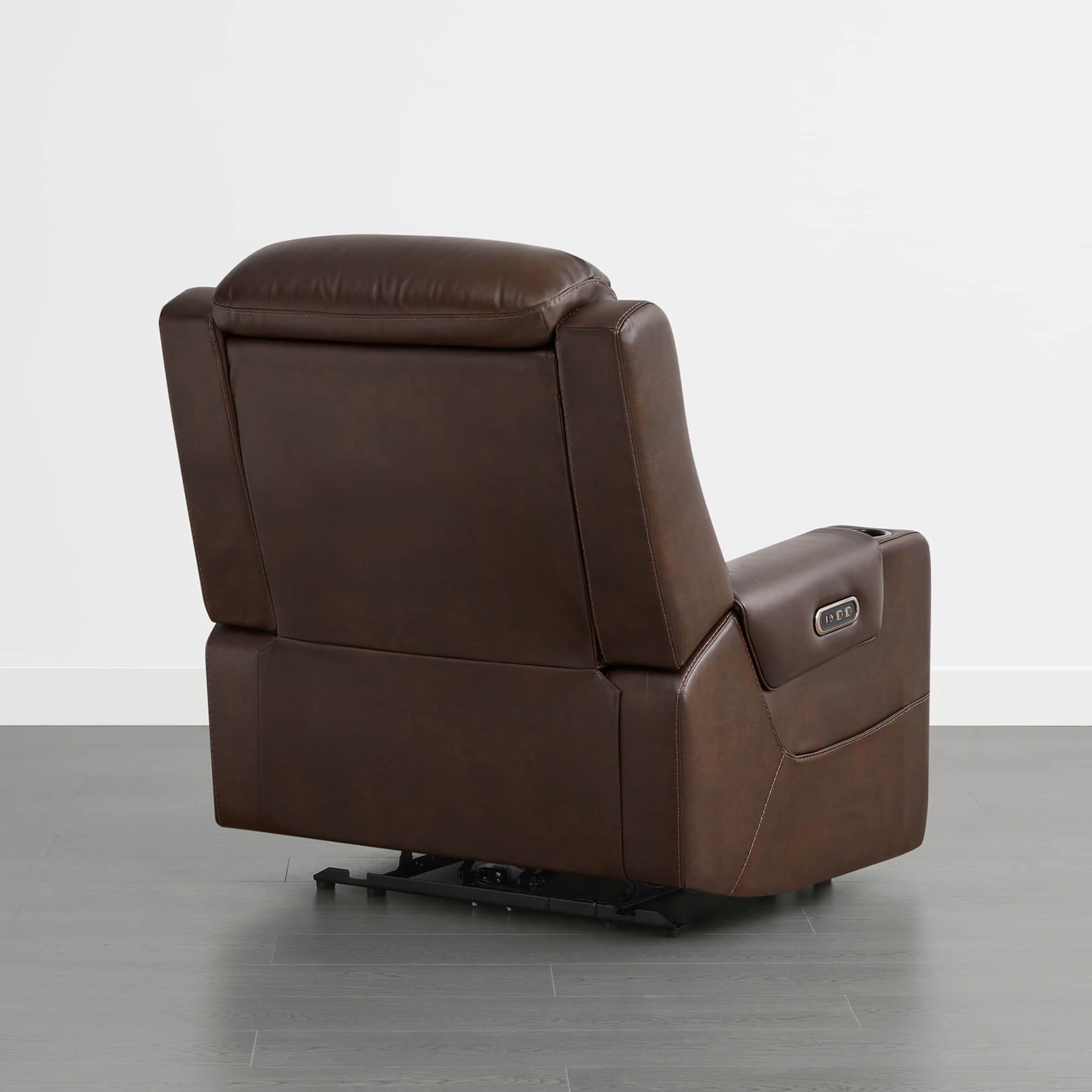 A dark brown leather recliner with a control panel on the armrest, shown from the back.