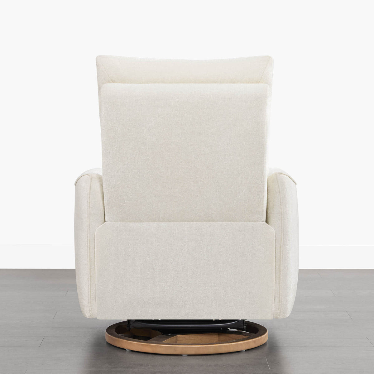 Rear view of Janice Power Swivel Nursery Glider Recliner in white fabric with wooden base.