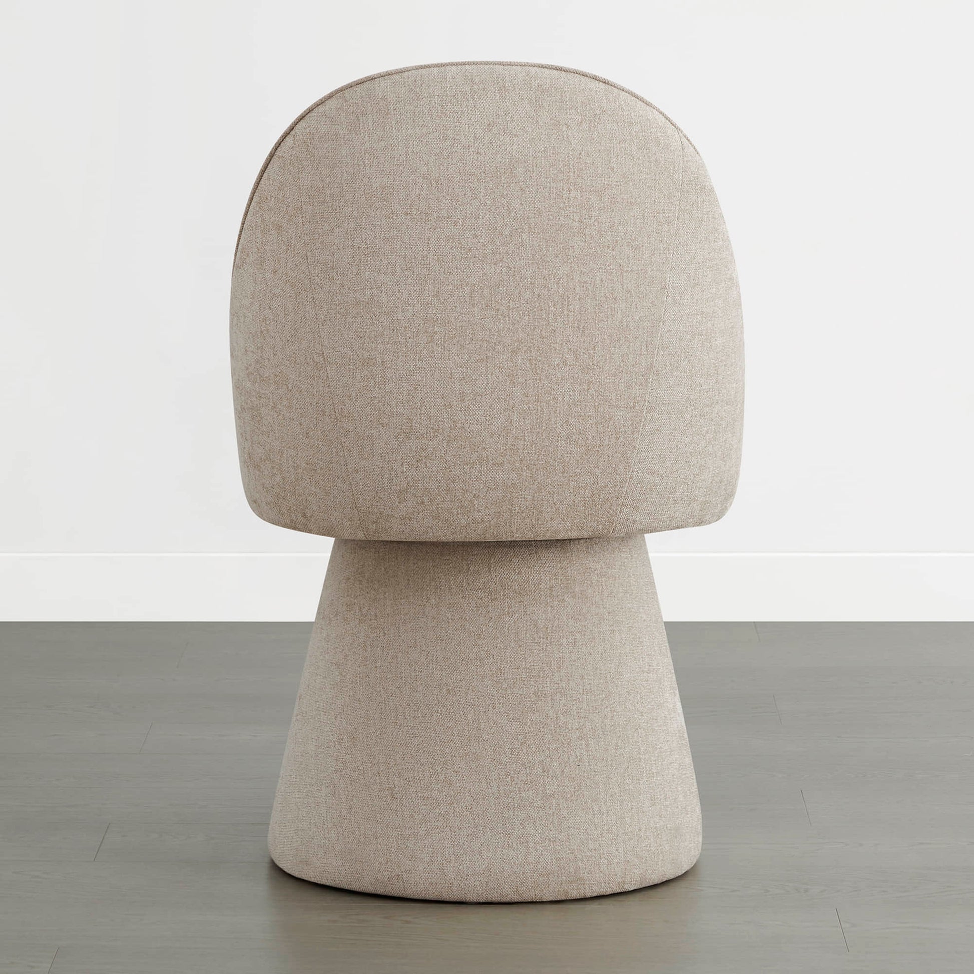 Back view of a beige swivel dining chair with a rounded backrest design.