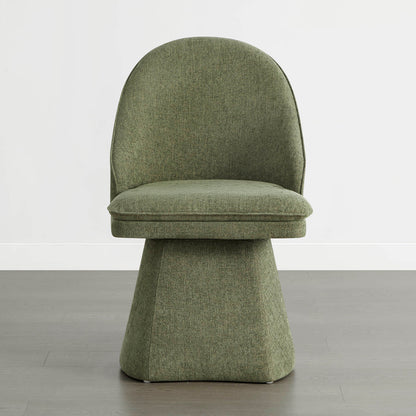 A single green swivel chair on a wooden floor against a white wall.