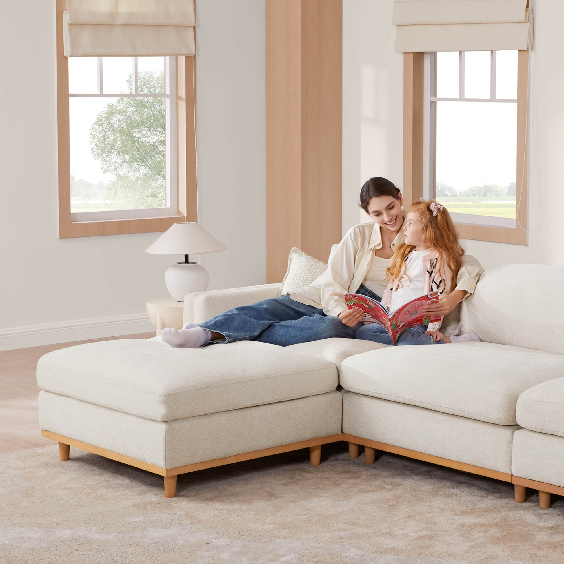 Mother and daughter reading on Liam 4-piece sectional sofa in modern bright living room - CHITA Living