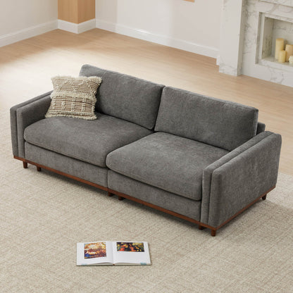 Gray modular sectional sofa with wood base and decorative pillow in modern living room - CHITA Living