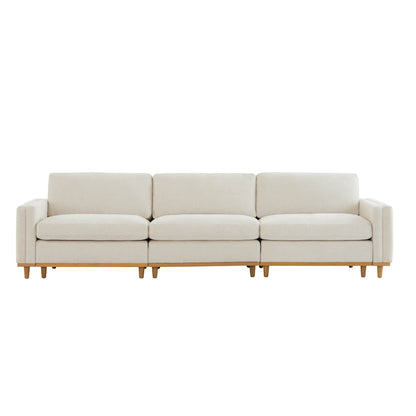 Liam 3-Piece Overstuffed Sofa with beige cushions and wooden base in bright room - CHITA Living