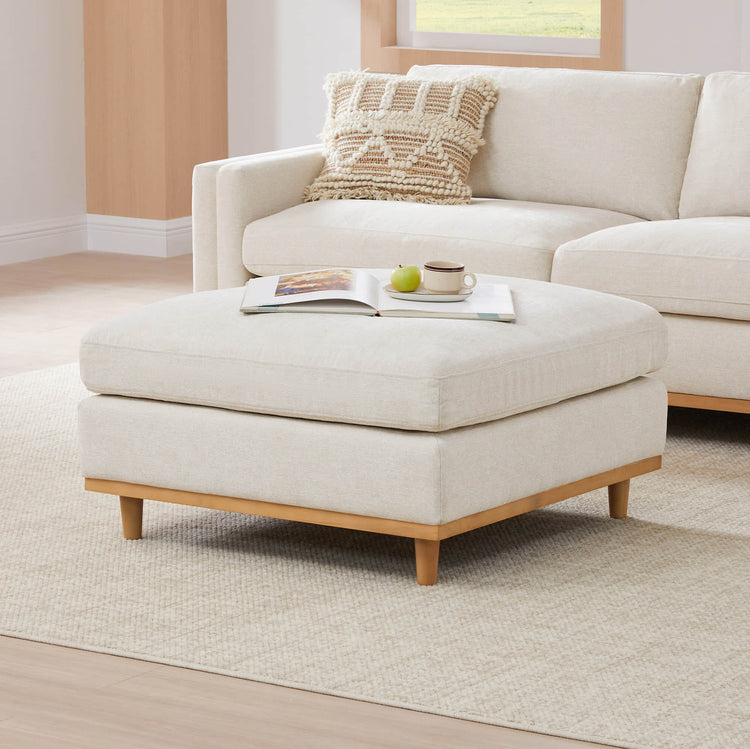 Liam Overstuffed Feather Ottoman with a soft cream fabric in a modern living room - CHITA Living