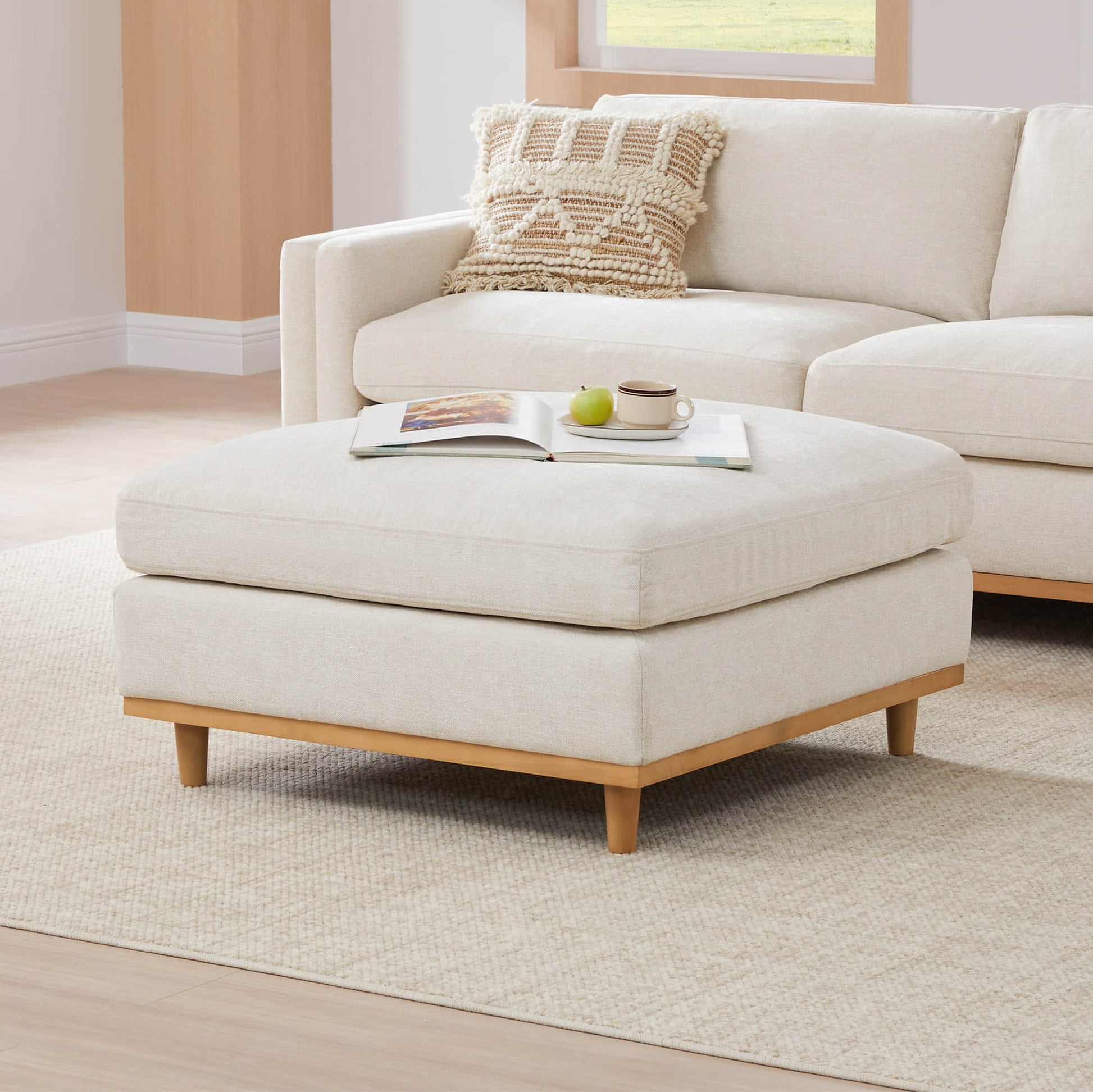 Liam overstuffed ottoman in bright, modern living room with natural textures - CHITA Living