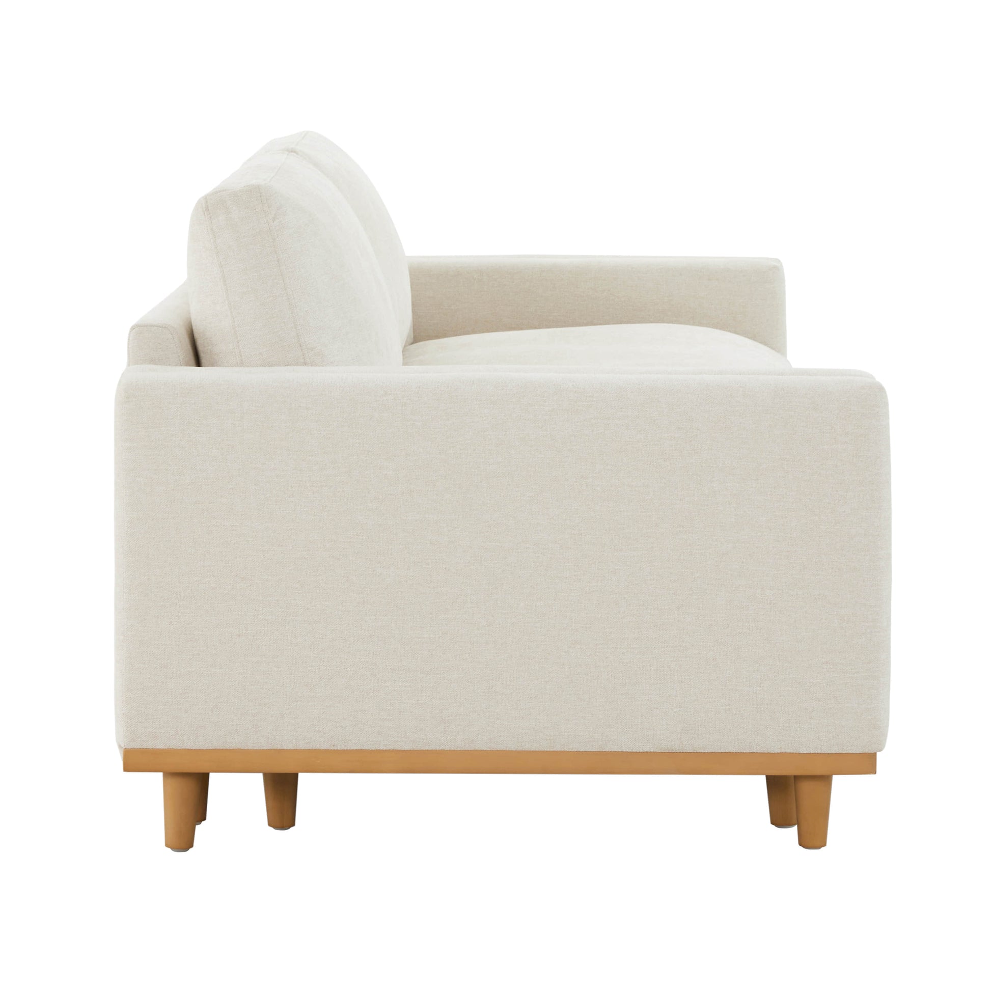 Side view of cream modular sofa with wooden legs in a stylish living room - CHITA Living