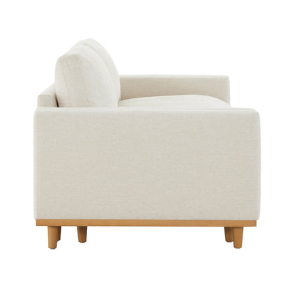 Side view of cream modular sofa with wooden legs in a stylish living room - CHITA Living
