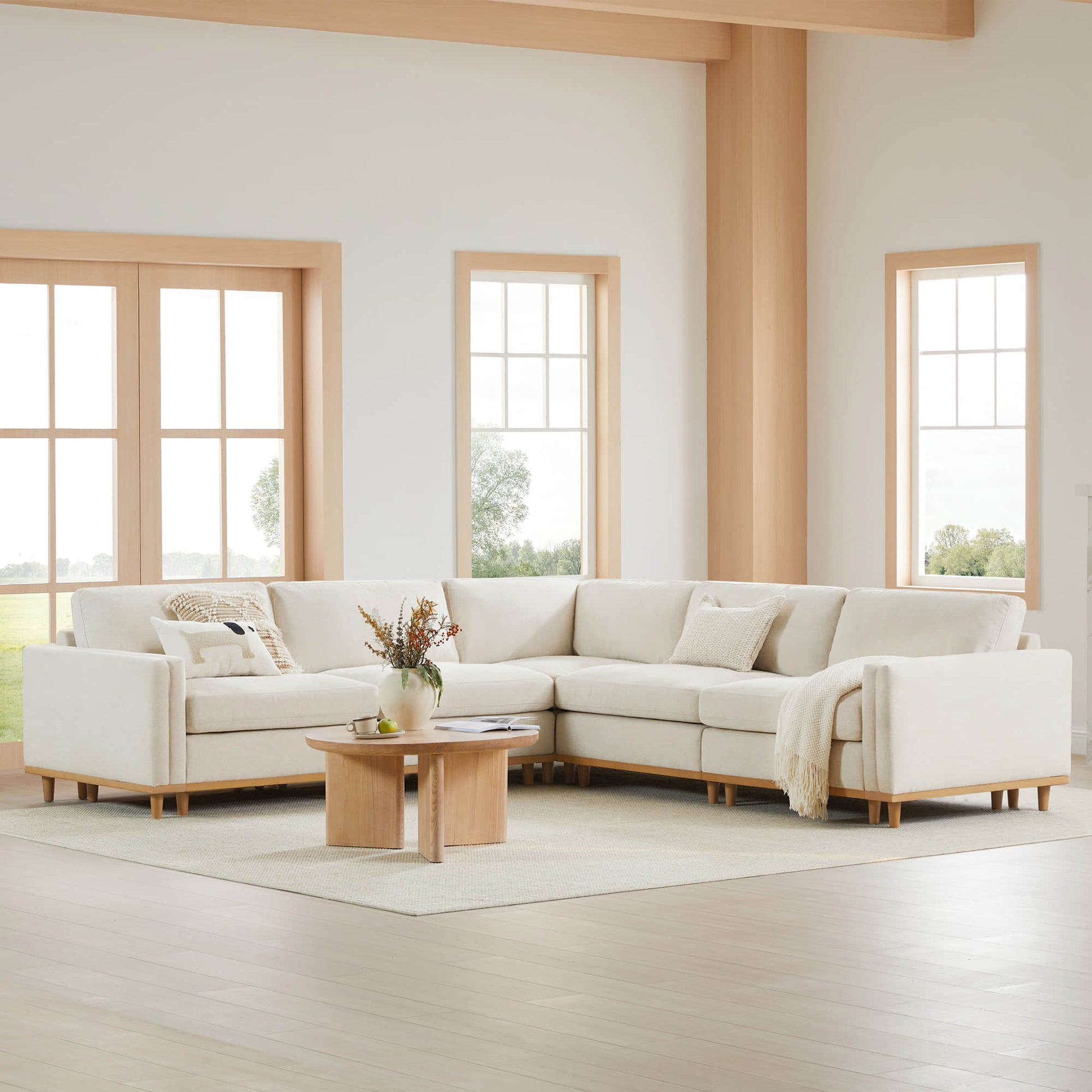 Liam 5-Piece Overstuffed Sectional in a bright living room with wooden accents and a coffee table - CHITA Living
