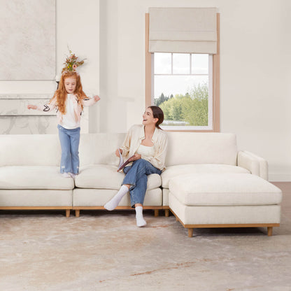 Woman and girl having fun on Liam overstuffed sectional sofa in modern bright living room - CHITA Living