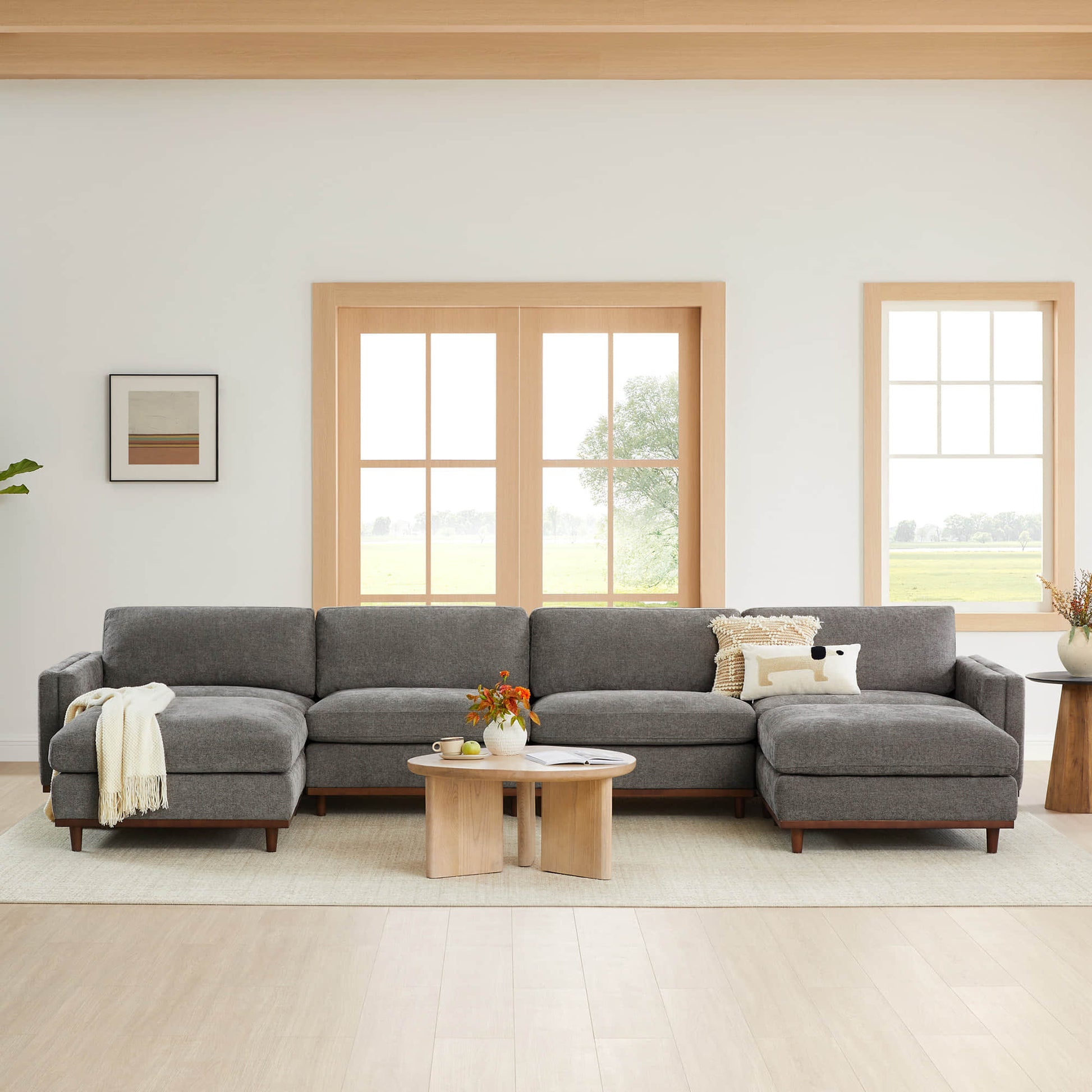 Liam 6-Piece Overstuffed Modular Sectional in grey fabric in bright living room with windows - CHITA Living