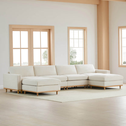 Liam modular sectional sofa in light fabric with wooden legs in a modern living space - CHITA Living