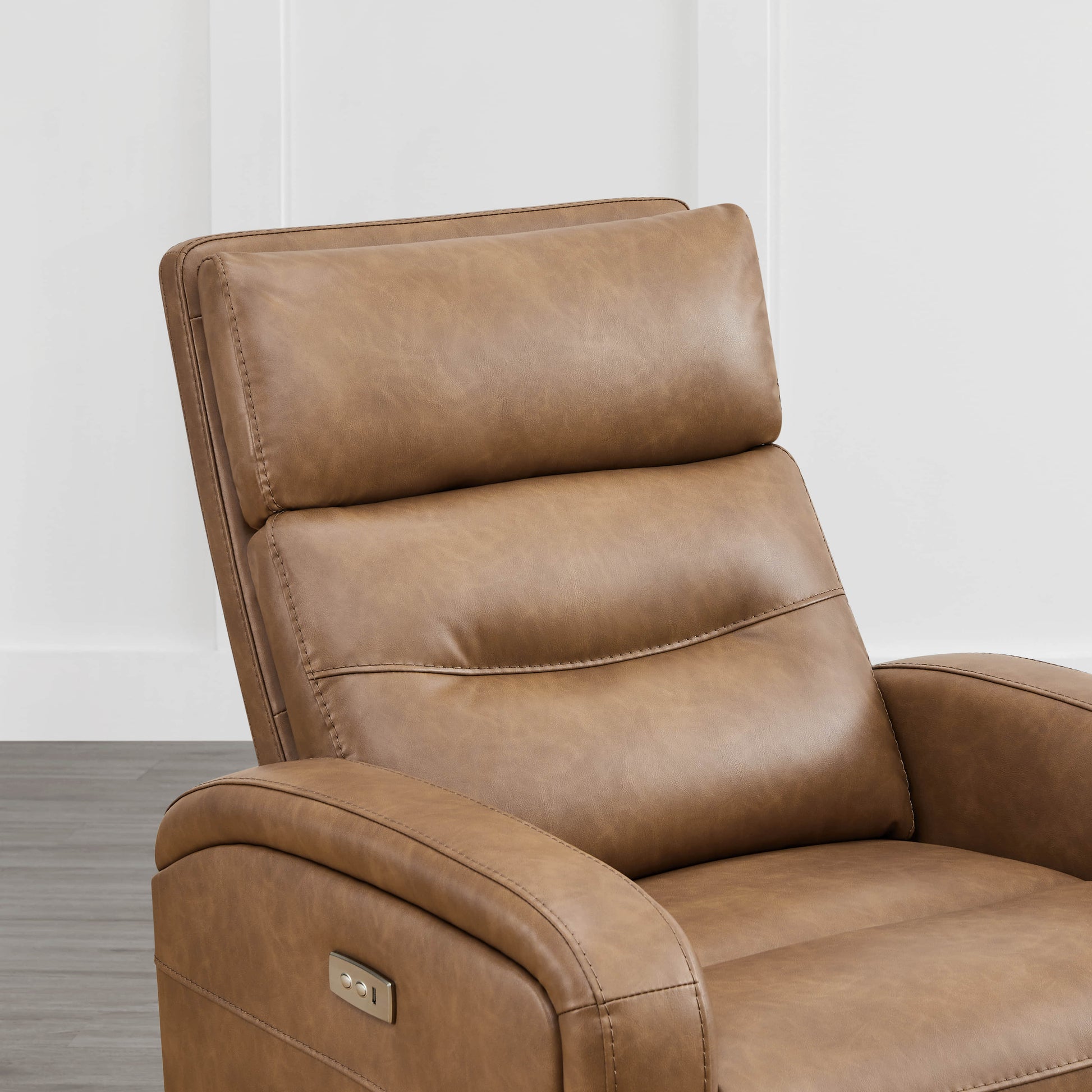 Close-up of tan leather Theo Power Swivel Glider Recliner's headrest and controls - CHITA Living